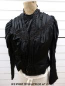 A black satin blouse with jet trimming and a set trimmed brocade cape with lace collar
