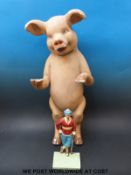 A butcher's advertising papier mache pig (height 67cm) and a cast metal figure of a golfer.
