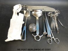 A small collection of orthopaedic surgery instruments to include a bone saw,