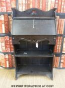 An oak Art Nouveau student's bureau with fall front and shelves below (H106 x W60 x D27cm)