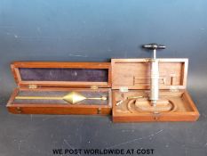A cased large metal syringe and attachments, possibly for lumbar puncture,