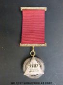 A Masonic medal stamped 9ct with inscription to back and dated 1874