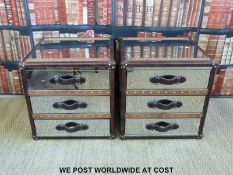 A pair of modern bedside tables in the form of mirrored,