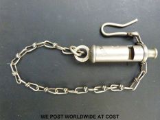 The Metropolitan police whistle marked Royal Irish Constabulary with chain and coat hook