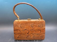 A vintage snake skin handbag with gilt mounts together with a German snakeskin cigarette case