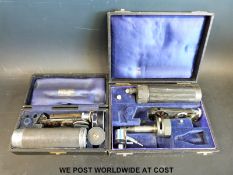 Two cased c1930s opthalmoscope,