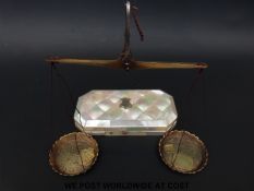 A mother of pearl cased set of travelling beam scales with engraved pans and various troy oz and