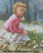 A framed oil of a young girl feeding birds (55cm x 45cm)