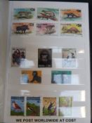 Two stockbooks of foreign stamps and a stockbook of New Zealand and GB stamps