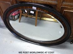 An oval bevelled edged mirror (H63 x W89cm)