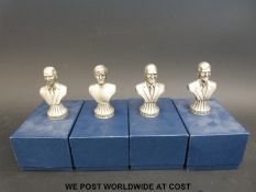 Four pewter football busts in boxes including Matt Busby, Bobby Charlton,