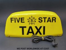 A 'Five Star' taxi magnetic roof sign