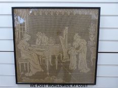 A large framed needlework or lace picture of a lady playing a piano,