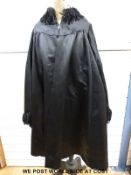 A grey silk bustle dress with elaborate trimmings,