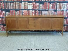 A retro G-Plan style sideboard and with cupboards either side of three drawers (H78 x W212 x