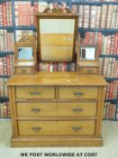 A satin walnut dressing chest with two over two drawers to base (H155 x W107 x D46cm)