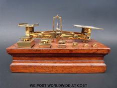 A set of J & E Ratcliff postage scales on base with square tapering weights to front