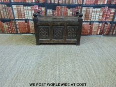 An Eastern panelled storage trunk with hinged top and carved decoration (H50 x W67 x D39cm)