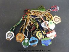 A quantity of enamel horse racing members badges,
