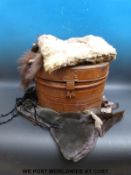 A vintage metal hat box containing a collection of furs etc