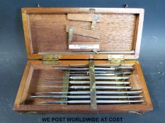 A mahogany cased set of surgical instruments with ivorine label 