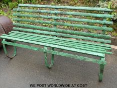 A wrought iron framed garden bench (length approximately 180cm)