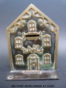 A late Victorian money box in the form of a Victorian house with 'Bank' above the door