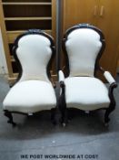A pair of carved mahogany upholstered chairs, one with arms,