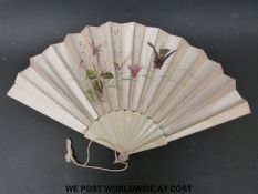 An ivory and silk painted fan decorated with birds in foliage