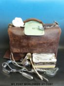 A leather midwife's / obstetrician's bag containing delivery forceps, autoclave / sterilising tray,