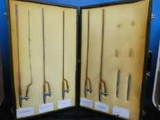 A selection of cased mid-20thC catheters with dilation attachments