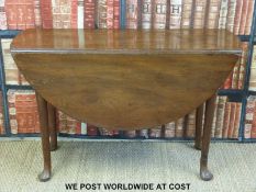A mahogany oval drop leaf table raised on cabriole legs (H71 x W116 x D107cm)