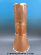 A copper and brass Casella rain gauge