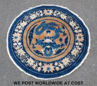 A red ground rug with diamond medallions to the centre,