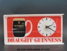 A Draught Guinness advertising clock (width 36cm)