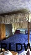 A mahogany four poster bed with silk top