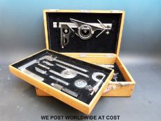 A wooden cased set of precision tools on two drawers marked Starrett & Co to the tools
