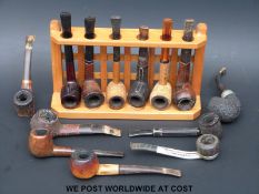 A collection of vintage pipes and stands, to include Dunhill,