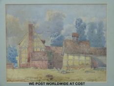 A framed 1884 watercolour of cottages,