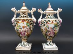 A pair of Capodimonte pot pourri in the form of pedestal vases with figural lids (41cm)