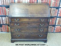 A Georgian oak bureau, the interior with drawers and various secret compartments,