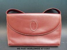 A red leather Cartier handbag