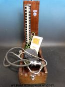 An Accoson sphygmomanometer in wooden case with cuff,