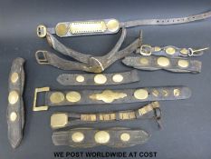 A quantity of horse harnesses with brass mounts,