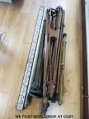 Five surveyor's or similar tripods including a WW2 military example and two surveyor's staffs