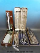 A collection of cased medical equipment including white metal catheters,