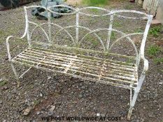 A late 18th / early 19thC wrought iron garden bench with hoop design to back and reeded decoration
