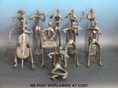 A bronze orchestra of ten musicians including cello, violin,
