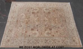 A large wool rug with floral decoration on beige ground (360cm x 273cm)