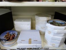 A large collection of Franklin Mint plates showing the career of John Wayne